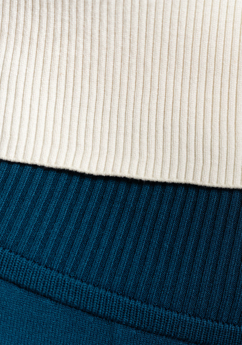 Texture close-up of the Women's Camille Ribbed Crop Top in ivory paired with ocean blue sweats showing the texture of the ribbed design
