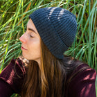 Woman outdoors wearing a Unisex Brooklyn Beaniein dark gray (basalt)