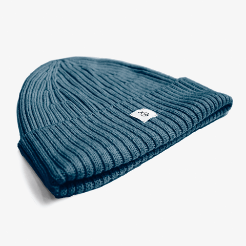 Blue Unisex Brooklyn Beanie presented on a white surface with a white NoNetz logo