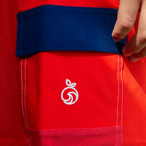 Close up of a pocket detail on a red swim trunk showing nonetz logo