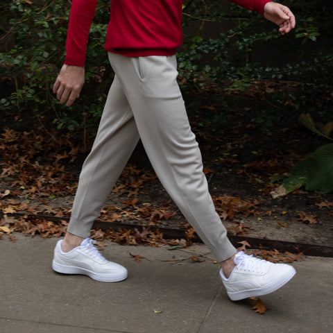 Side view of Men's Chase Jogger in cement tan with a model in motion