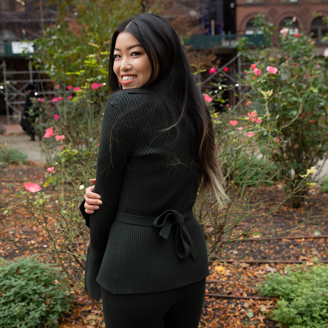 Sustainable fashion greeen sweater girl in a garden