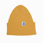 Yellow beanie with a brand label on a white background