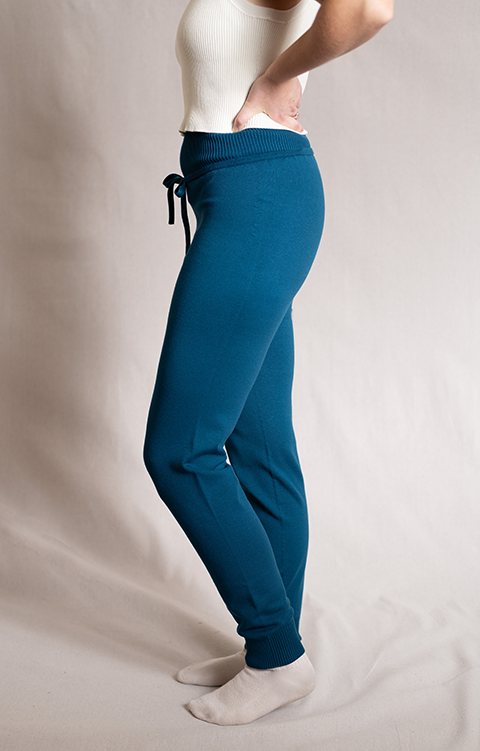 Side picture of woman wearing blue joggers