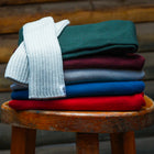 Fingerless Gloves on a stool with other sweaters