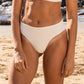 Waist down front of a woman in a white bikini fashioning sustainability