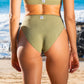 Back of a woman in a sage green bikini in front of the ocean fashion and sustainability