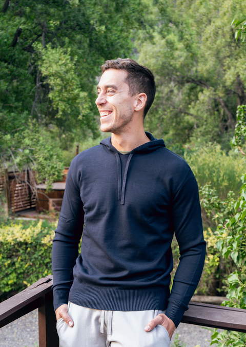 Man posing in "Carter Classic" hoodie and joggers on wooden decking