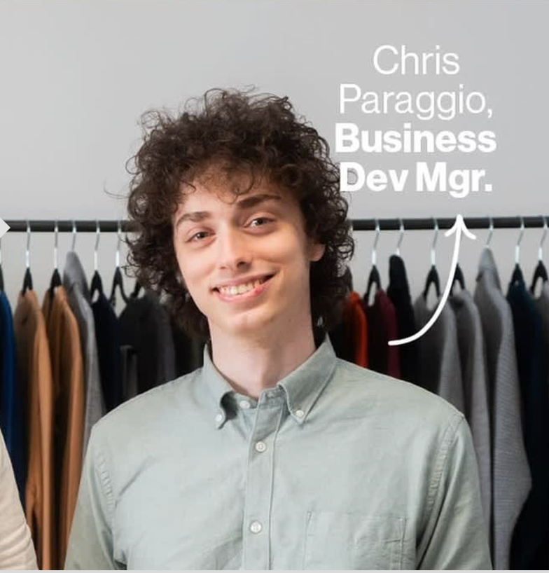 Chris Paraggio standing in front of a clothing rack