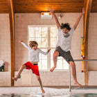 Two children having fun in a pool wearing NoNetz swim wear