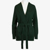 The Women's Callie Long Sleeve Front Tie Sweater presented in a green shade with belt tied at the waist on a white mannequin