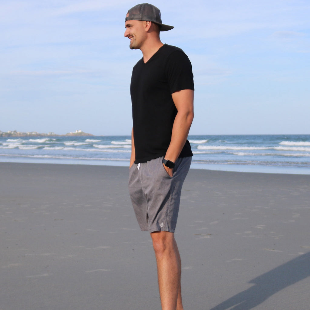 Model showcasing Men's Haven Regular Fit 8" Inseam Swim Trunks on the beach