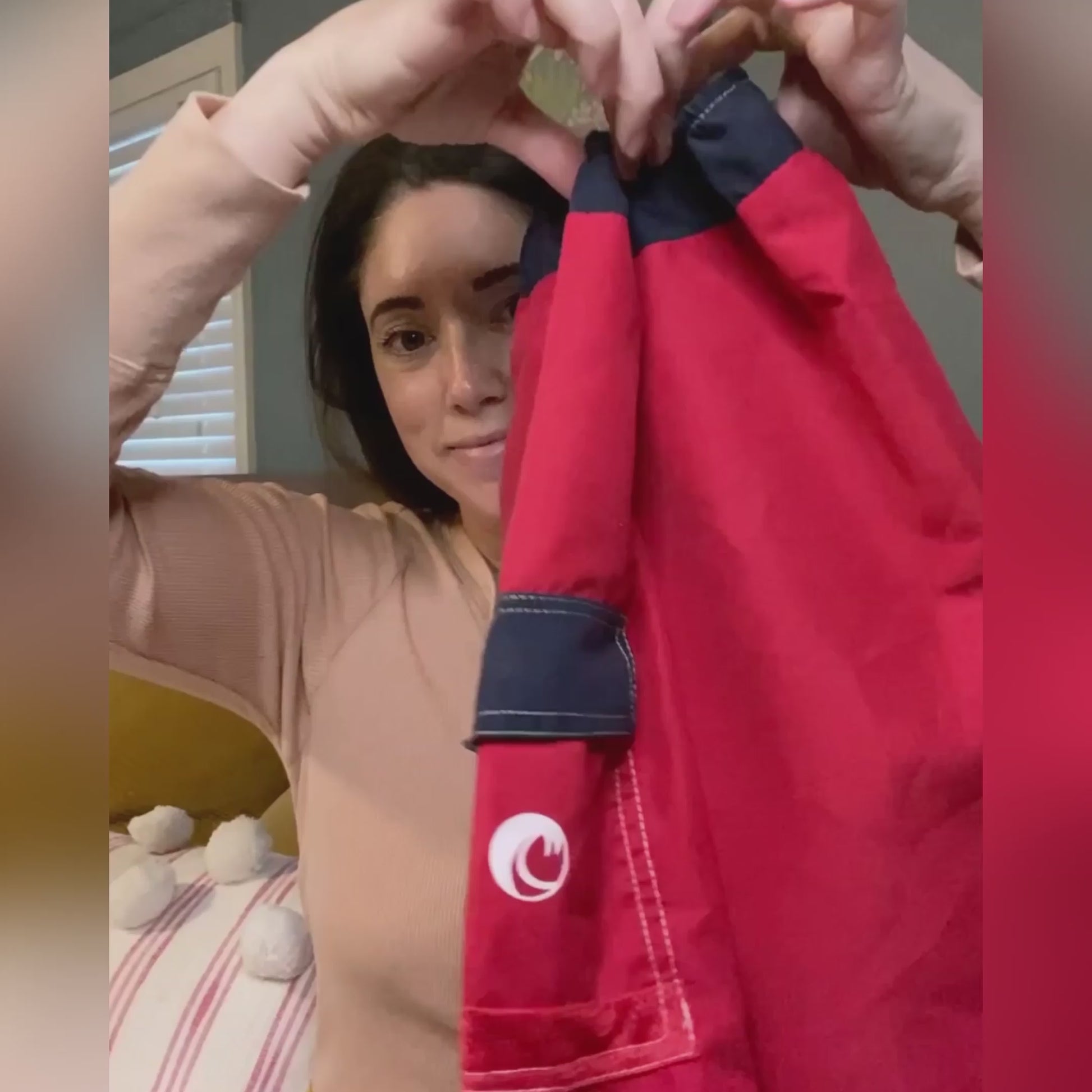 Mom reviewing a NoNetz boys red swim trunk